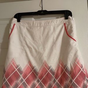 White with pink and black design Izod golf skort